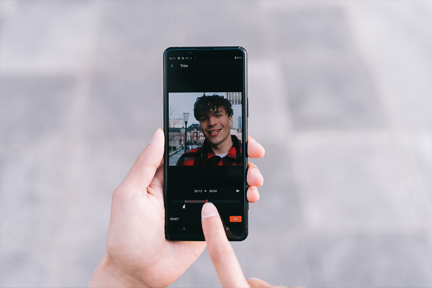 Situational image of a person using their smartphone to edit a movie