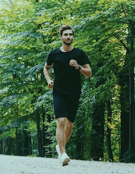 Man running through a forest