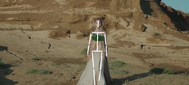 Example image showing a woman walking on sand, with human pose estimation recognising her head and body