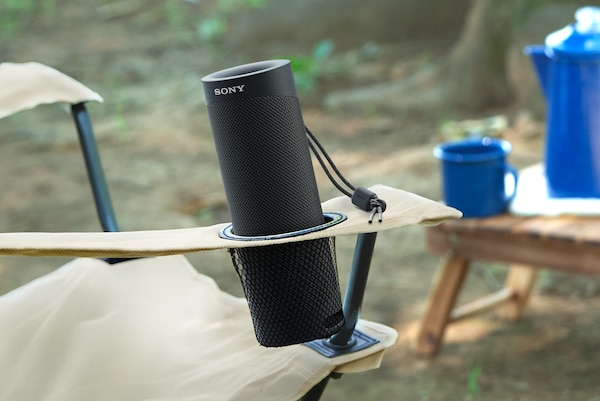 SRS-XB23 outdoors in collapsible chair cup-holder.