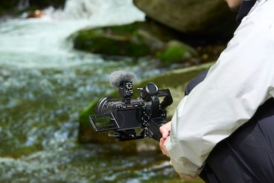 Usage image showing camera mounted on a gimbal with a river in the background