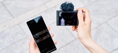 Image in which a person transferring the data from camera to a smartphone