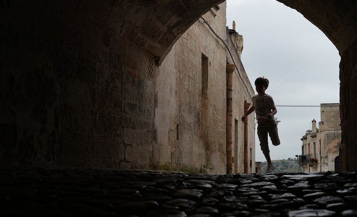 Example image showing a child running in a shaded tunnel