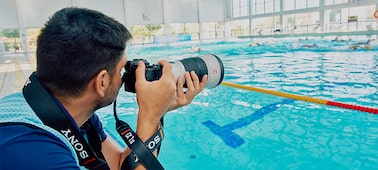 Usage image showing a man shooting at a large indoor swimming pool