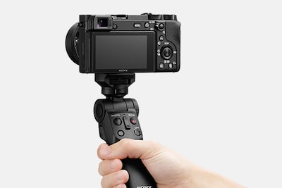 Image of a camera being held by an attached grip