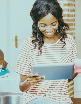 Lady at home looking at a tablet